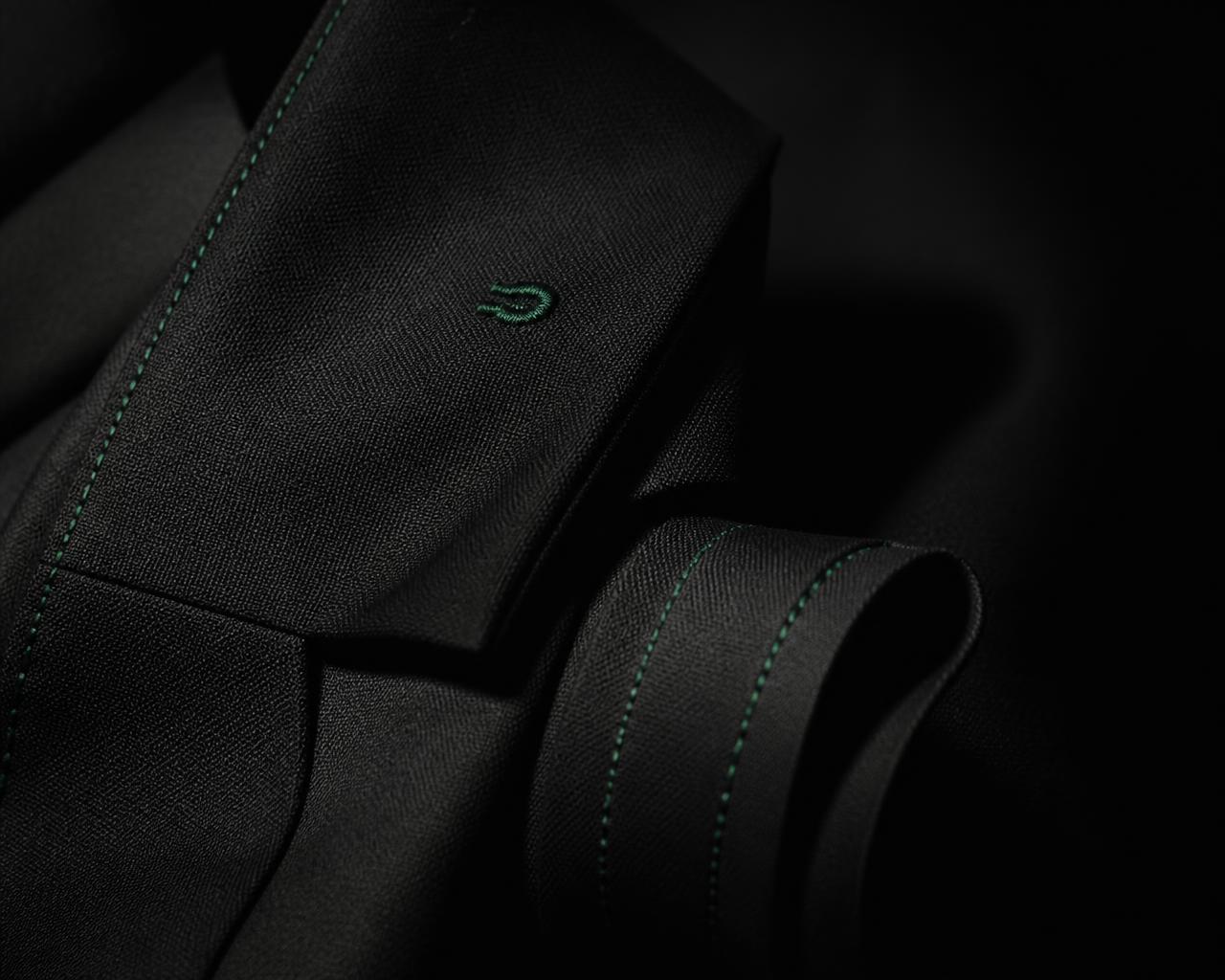 Black heavyweight fabric with forest green detail stitching